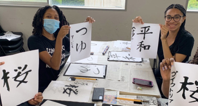 Spelman students practice shodo (Japanese calligraphy)